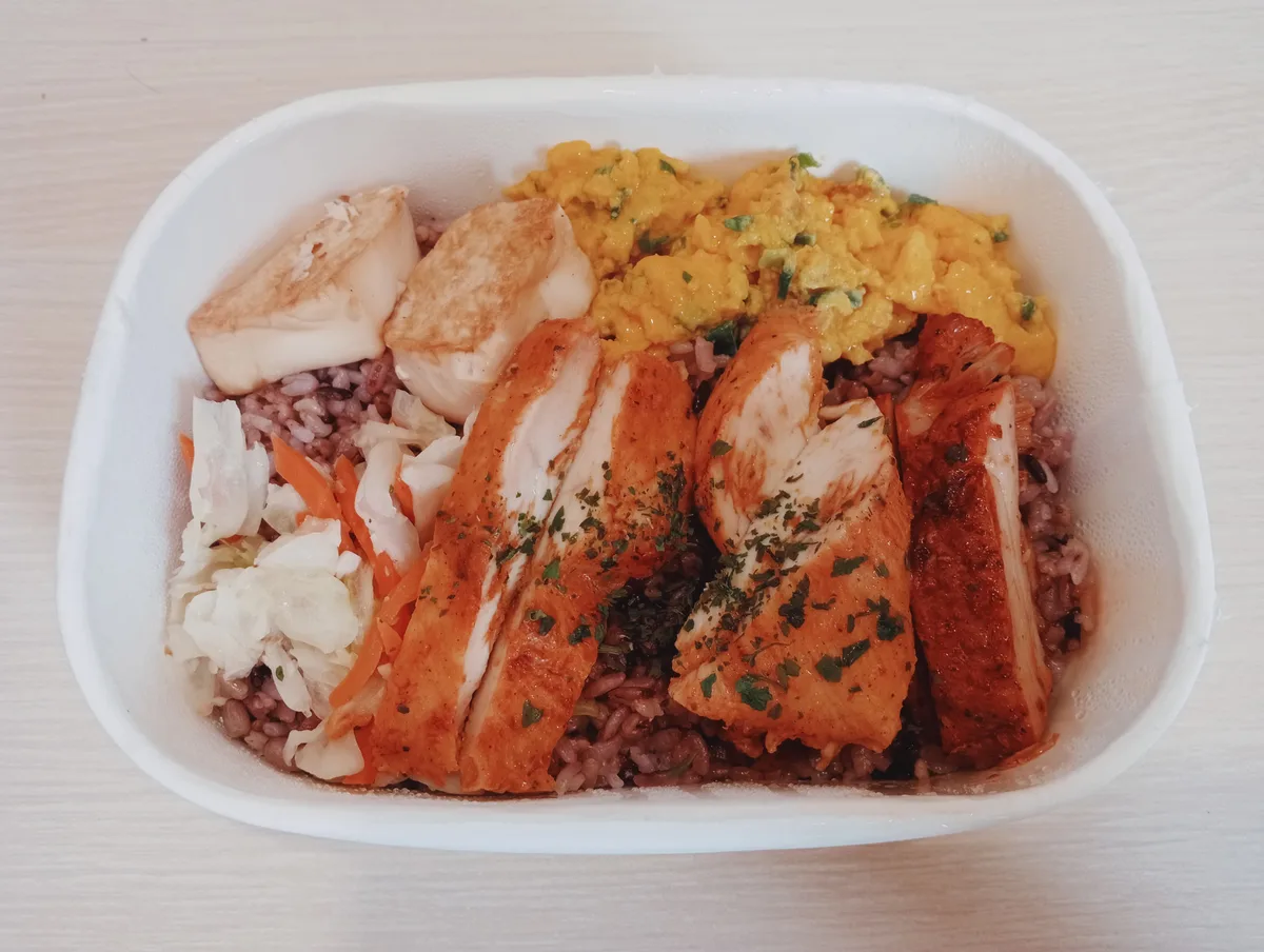 台灣便當裡的雞肉主菜、蛋、米飯和蔬菜。